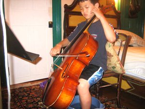 "Practicing at Meadowmount School of Music with my feet in cold water because of the intense heat that day. (Summer 2006)."